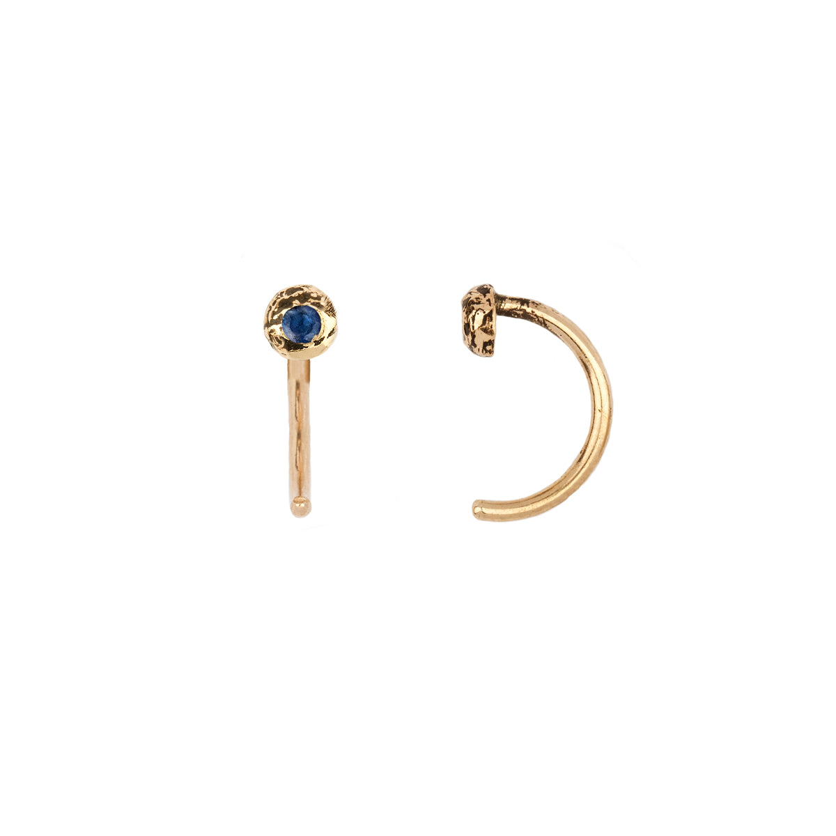 A set of 14k gold hug earrings set with a sapphire.