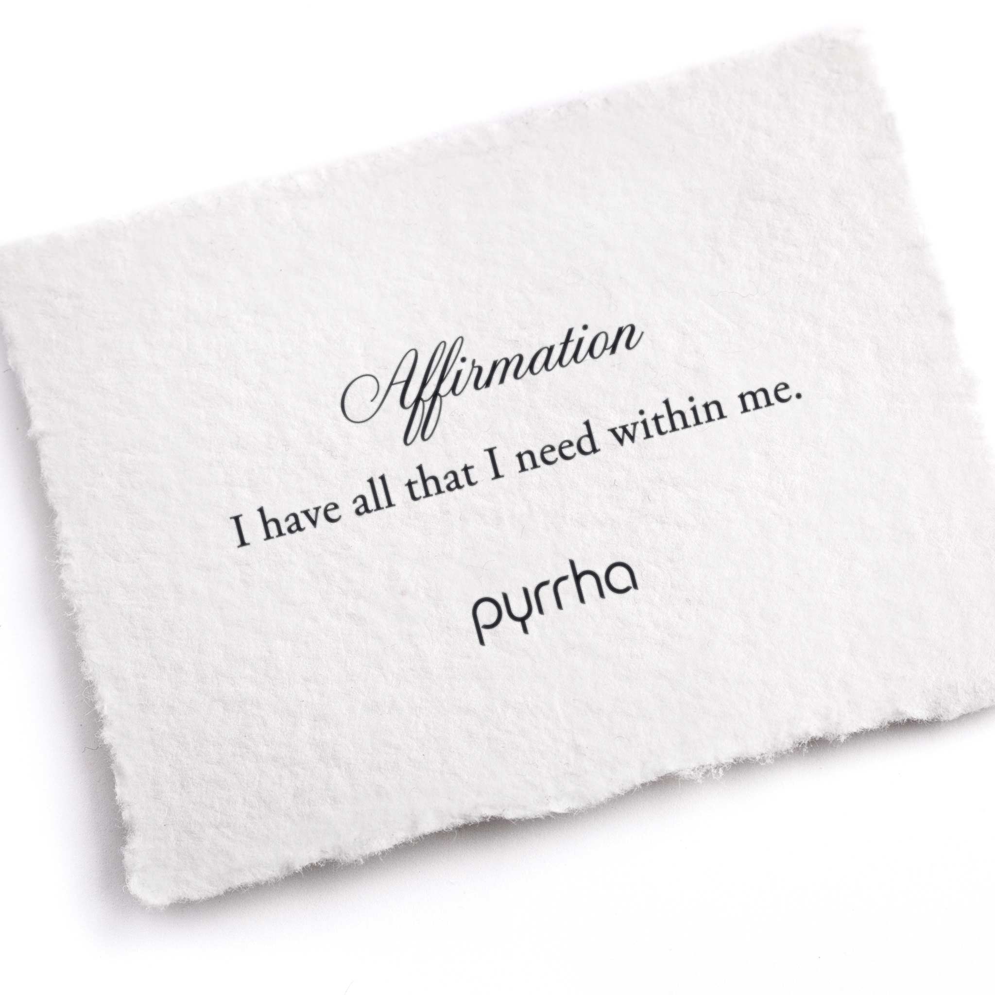 A hand-torn, letterpress printed card describing the meaning for Pyrrha's I have all that I need within me Affirmation Talisman