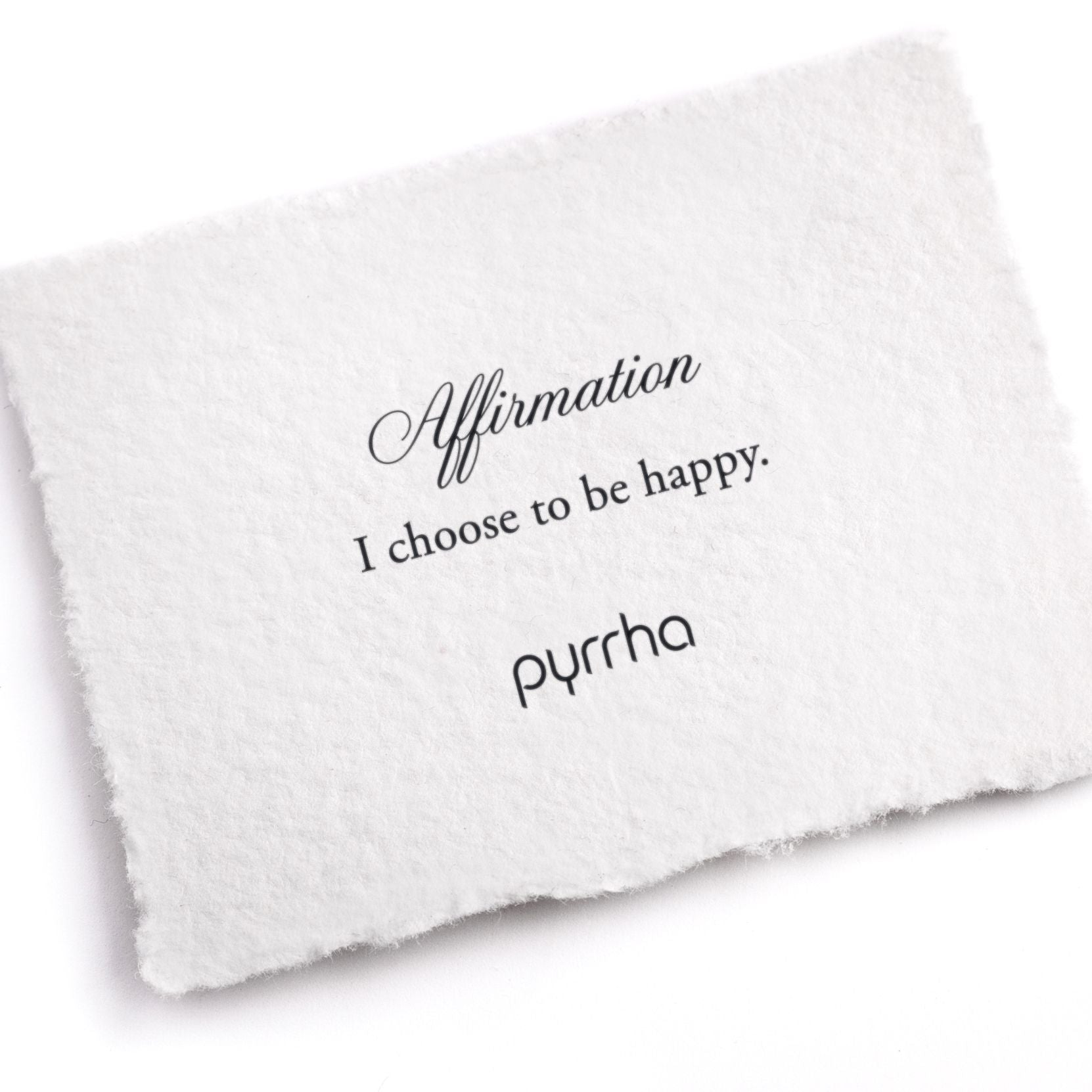 A hand-torn, letterpress printed card describing the meaning for Pyrrha's I choose to be happy Affirmation Talisman