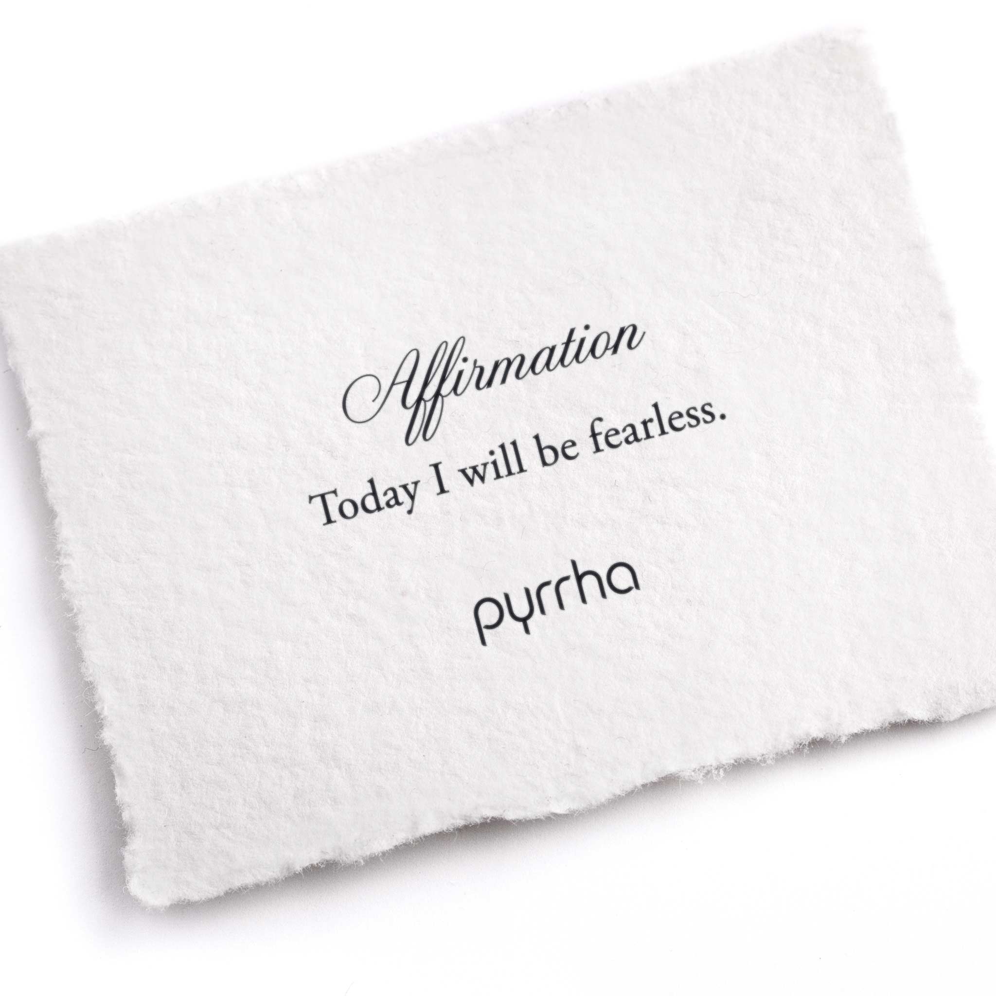 A hand-torn, letterpress printed card describing the meaning for Pyrrha's Today I will be fearless Affirmation Talisman