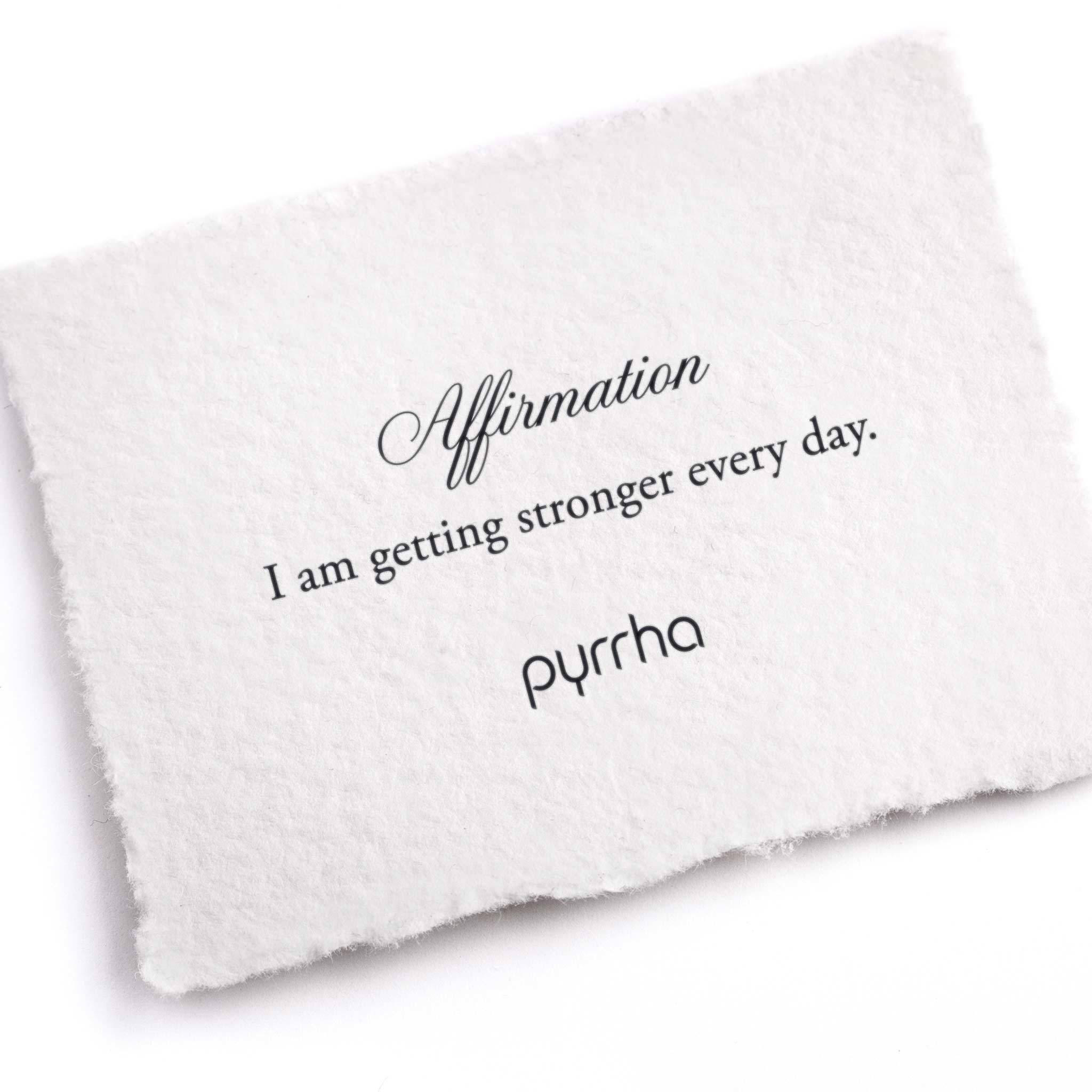 A hand-torn, letterpress printed card describing the meaning for Pyrrha's I am getting stronger every day Affirmation Talisman