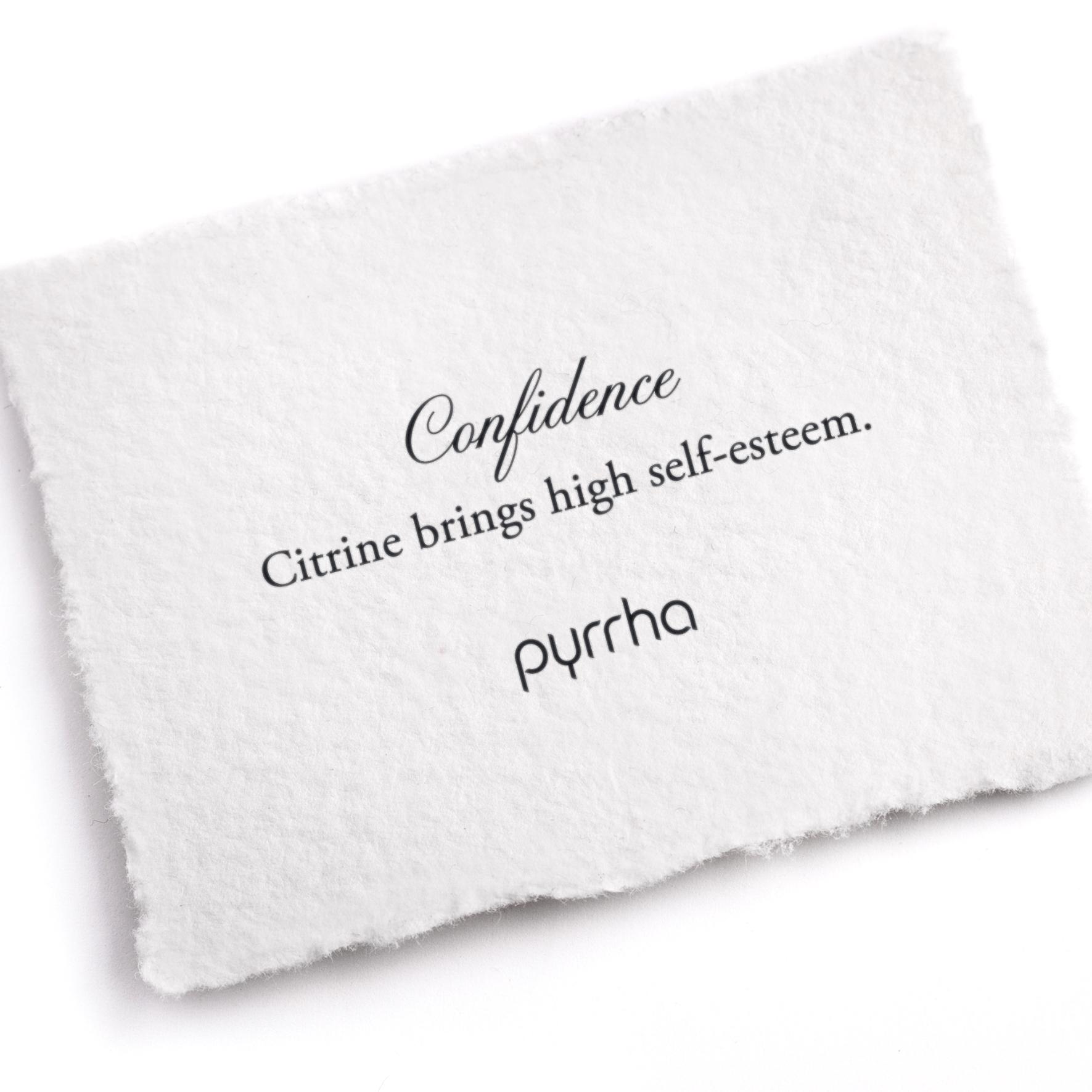 A hand-torn, letterpress printed card describing the meaning for Pyrrha's Confidence Attraction Charm
