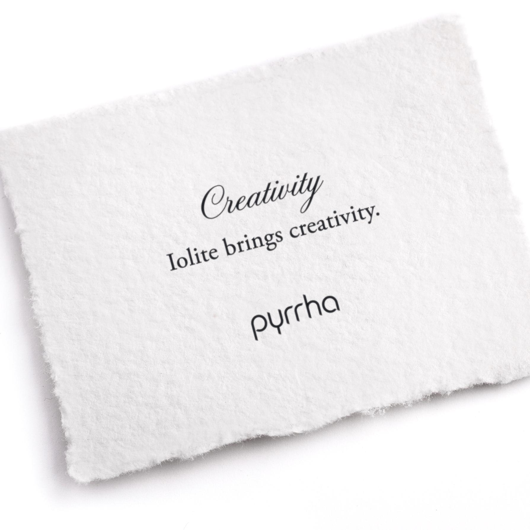 A hand-torn, letterpress printed card describing the meaning for Pyrrha's Creativity Attraction Charm