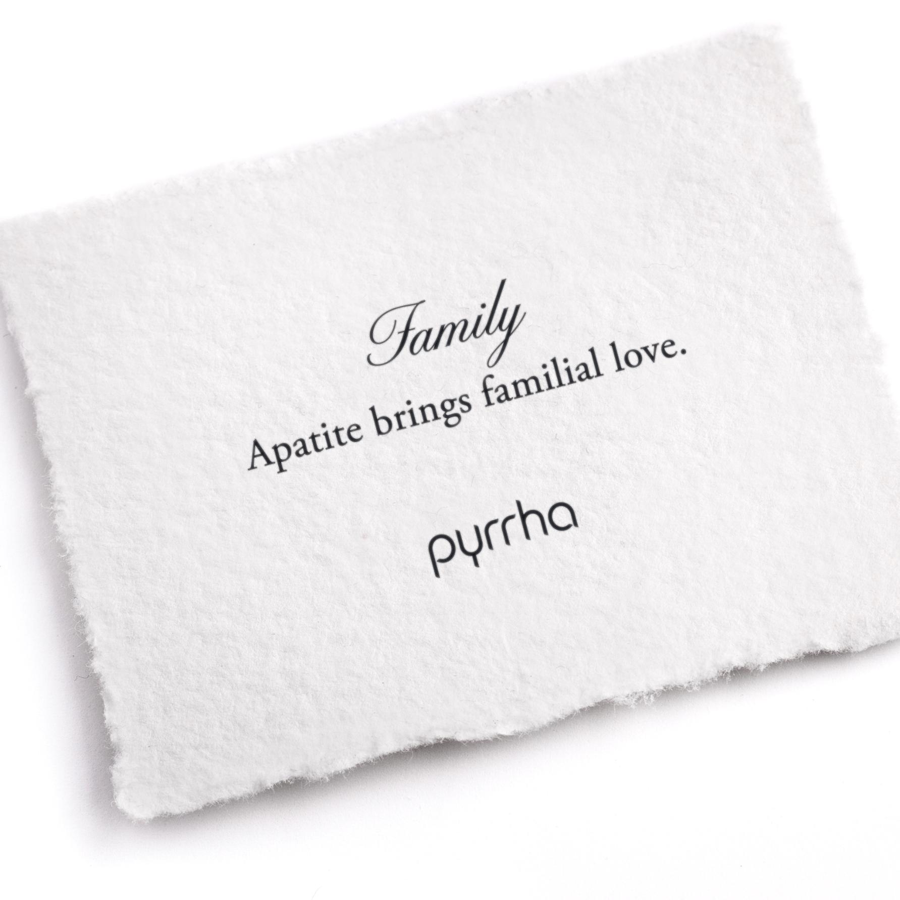 A hand-torn, letterpress printed card describing the meaning for Pyrrha's Family Attraction Charm