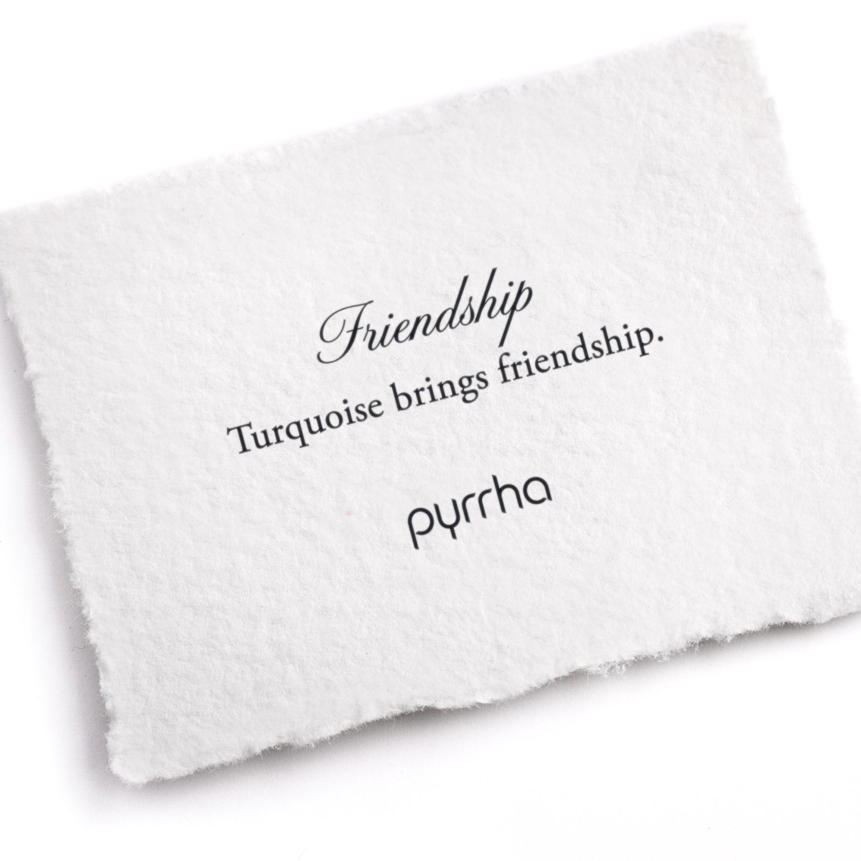 A hand-torn, letterpress printed card describing the meaning for Pyrrha's Friendship Attraction Charm