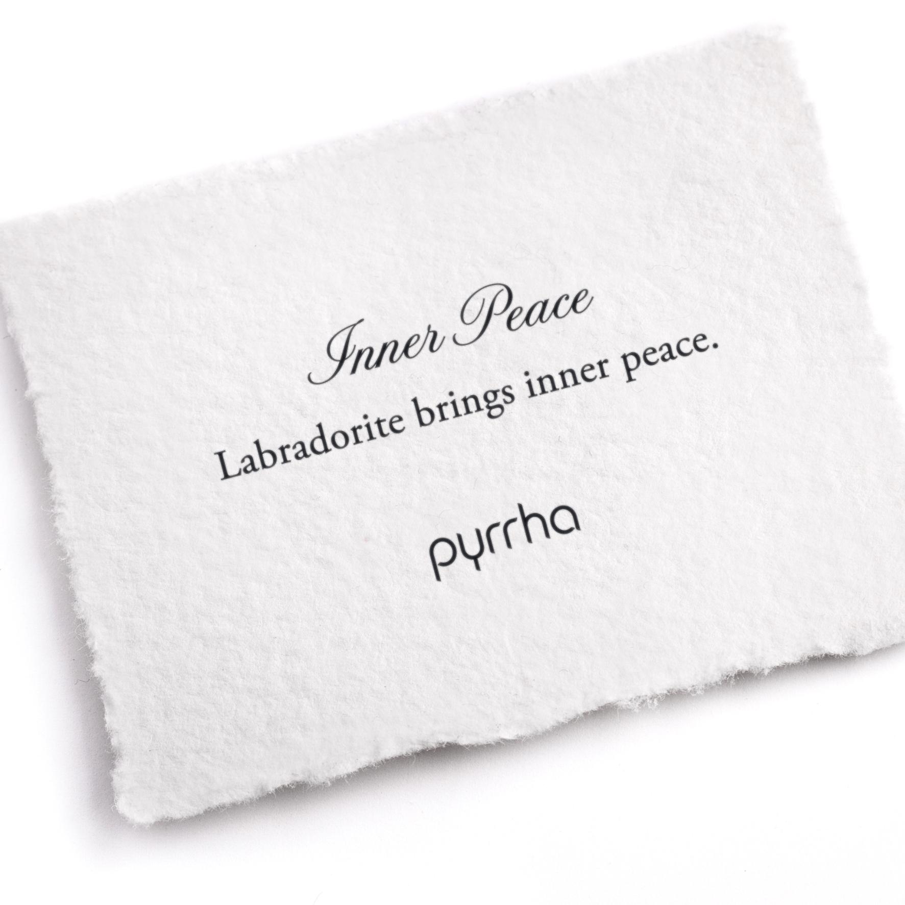 A hand-torn, letterpress printed card describing the meaning for Pyrrha's Inner Peace Attraction Charm
