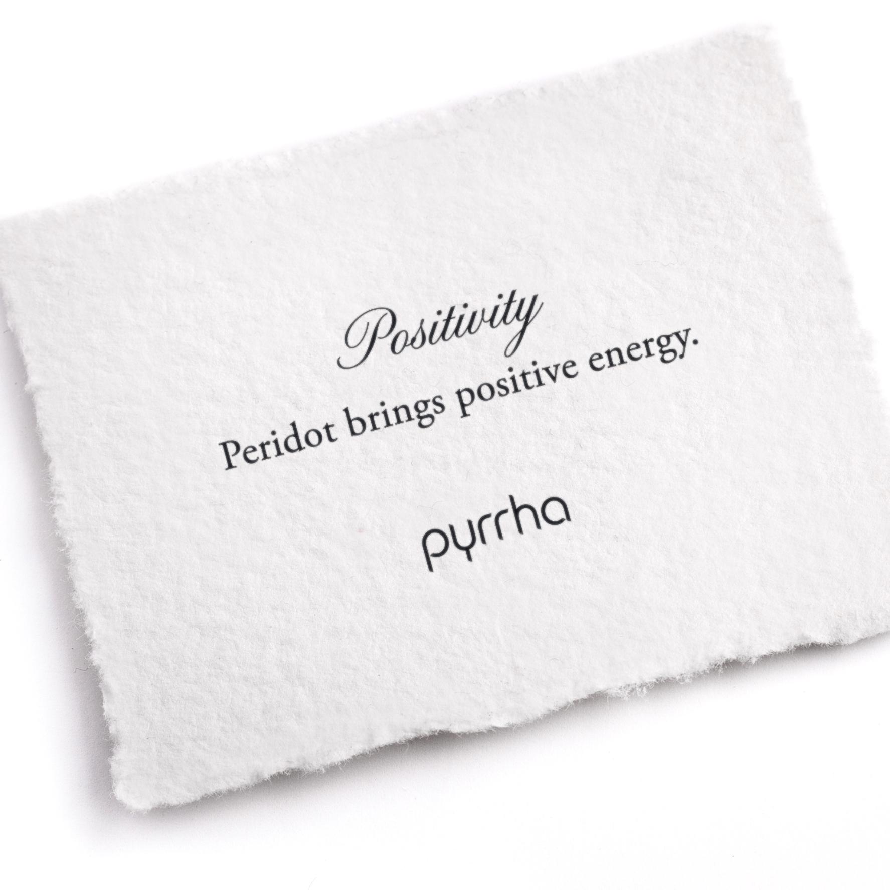 A hand-torn, letterpress printed card describing the meaning for Pyrrha's Positivity Attraction Charm