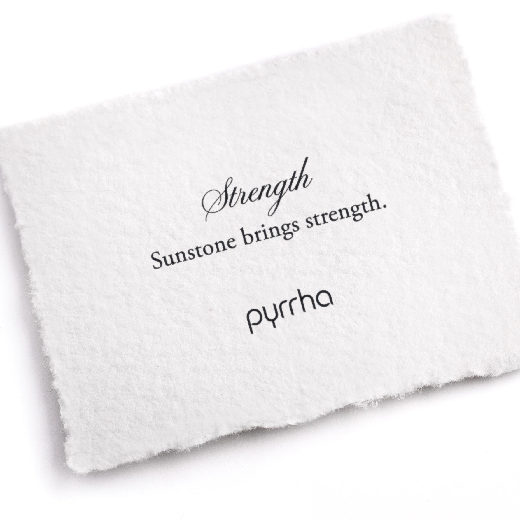 A hand-torn, letterpress printed card describing the meaning for Pyrrha's Strength Attraction Charm
