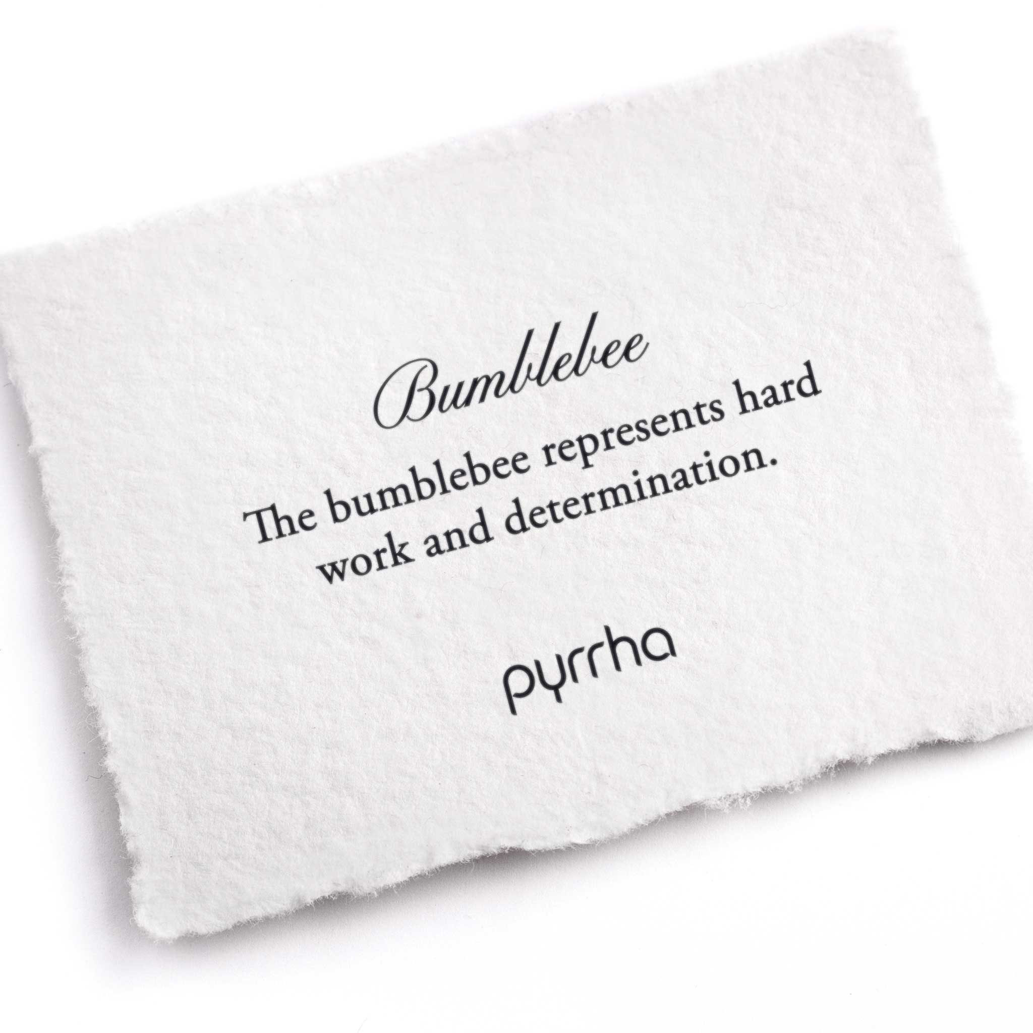 A hand-torn, letterpress printed card describing the meaning for Pyrrha's Bumblebee Charm