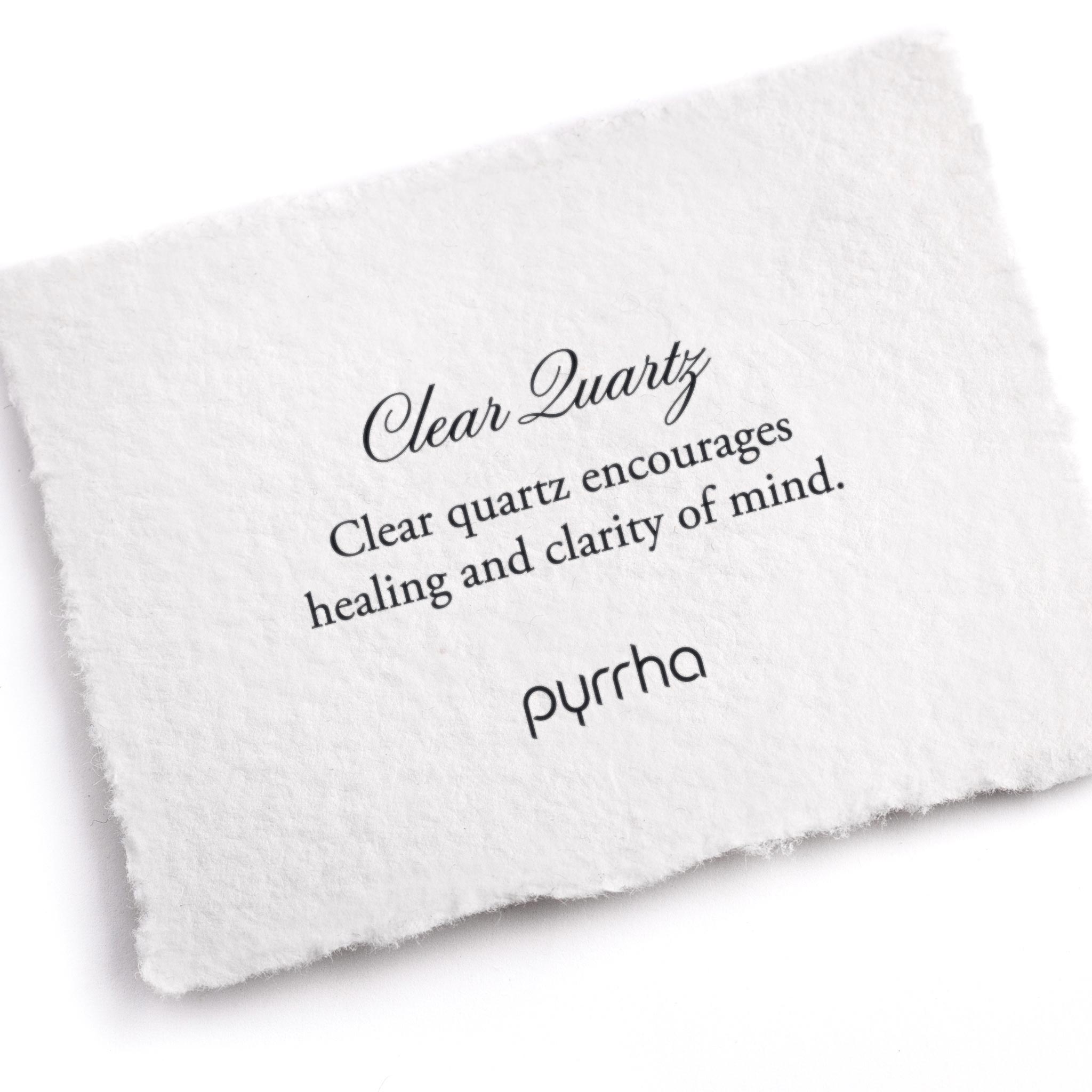 A hand-torn, letterpress printed card describing the meaning for Pyrrha's Clear Quartz stone