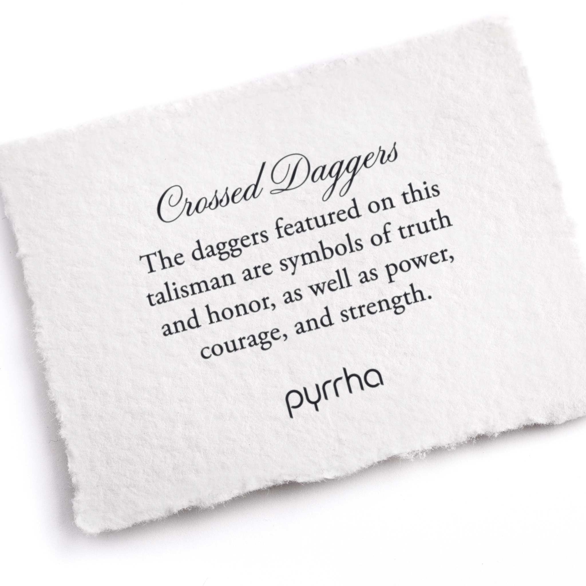 A hand-torn, letterpress printed card describing the meaning for Pyrrha's Crossed Daggers Talisman