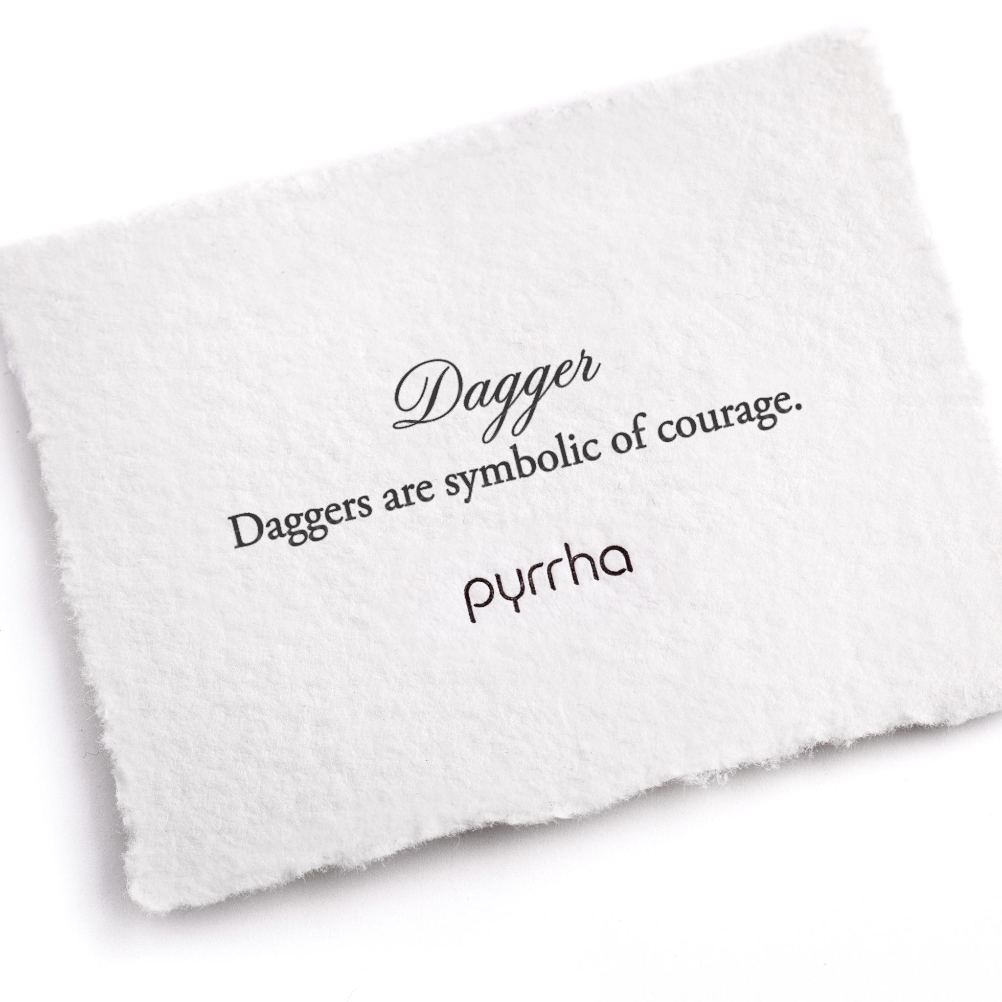 A hand-torn, letterpress printed card describing the meaning for Pyrrha's Dagger Symbol Charm