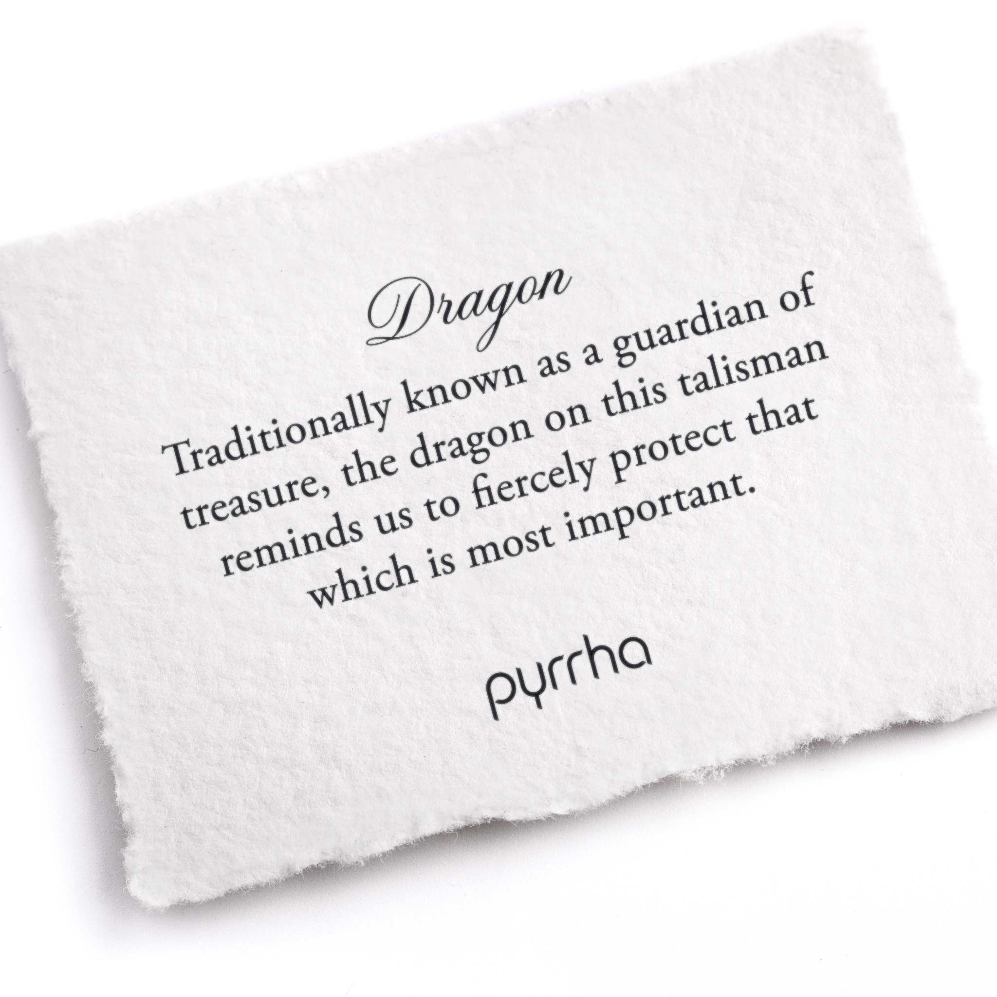 A hand-torn, letterpress printed card describing the meaning for Pyrrha's Dragon Talisman
