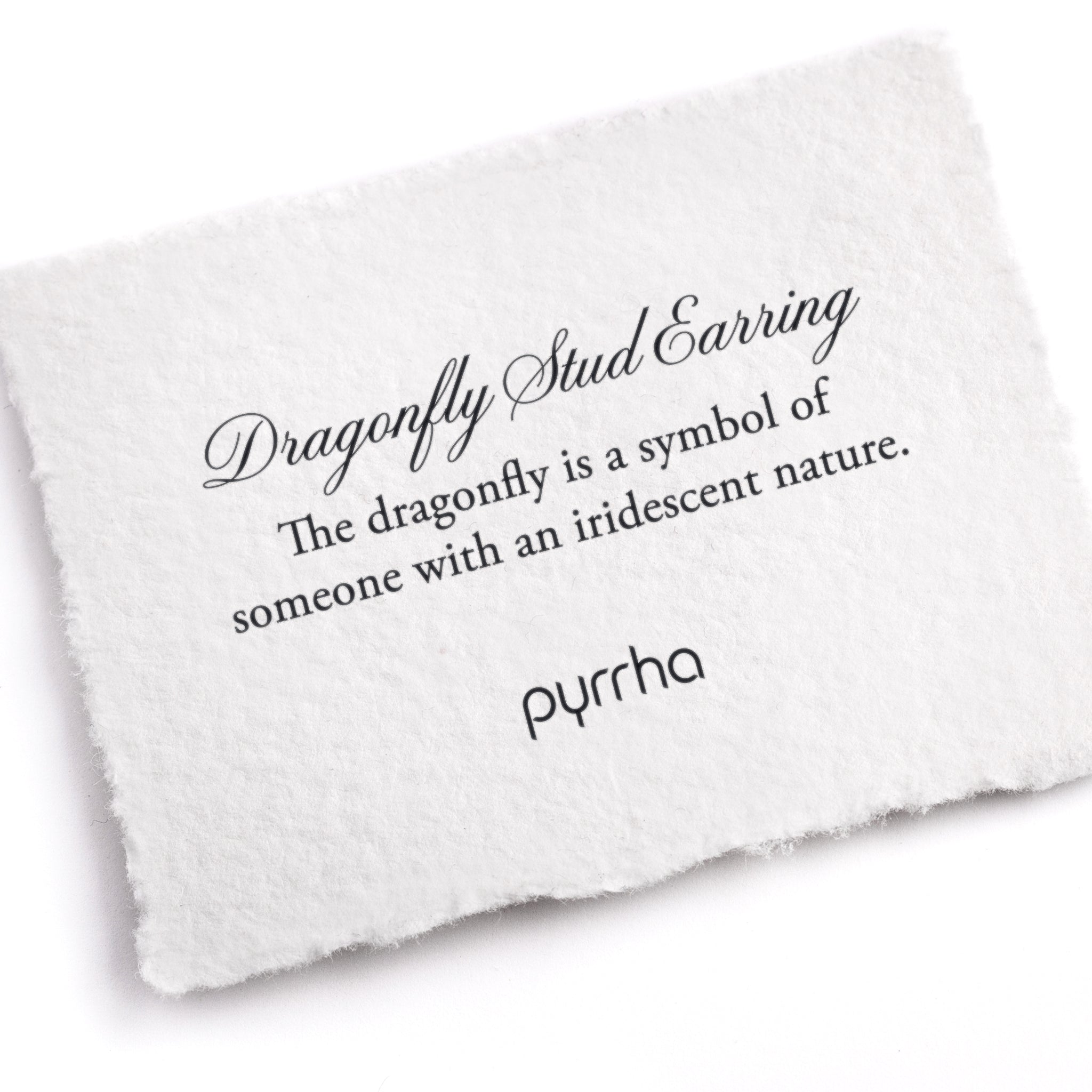 A hand-torn, letterpress printed card describing the meaning for Pyrrha's Dragonfly Charm