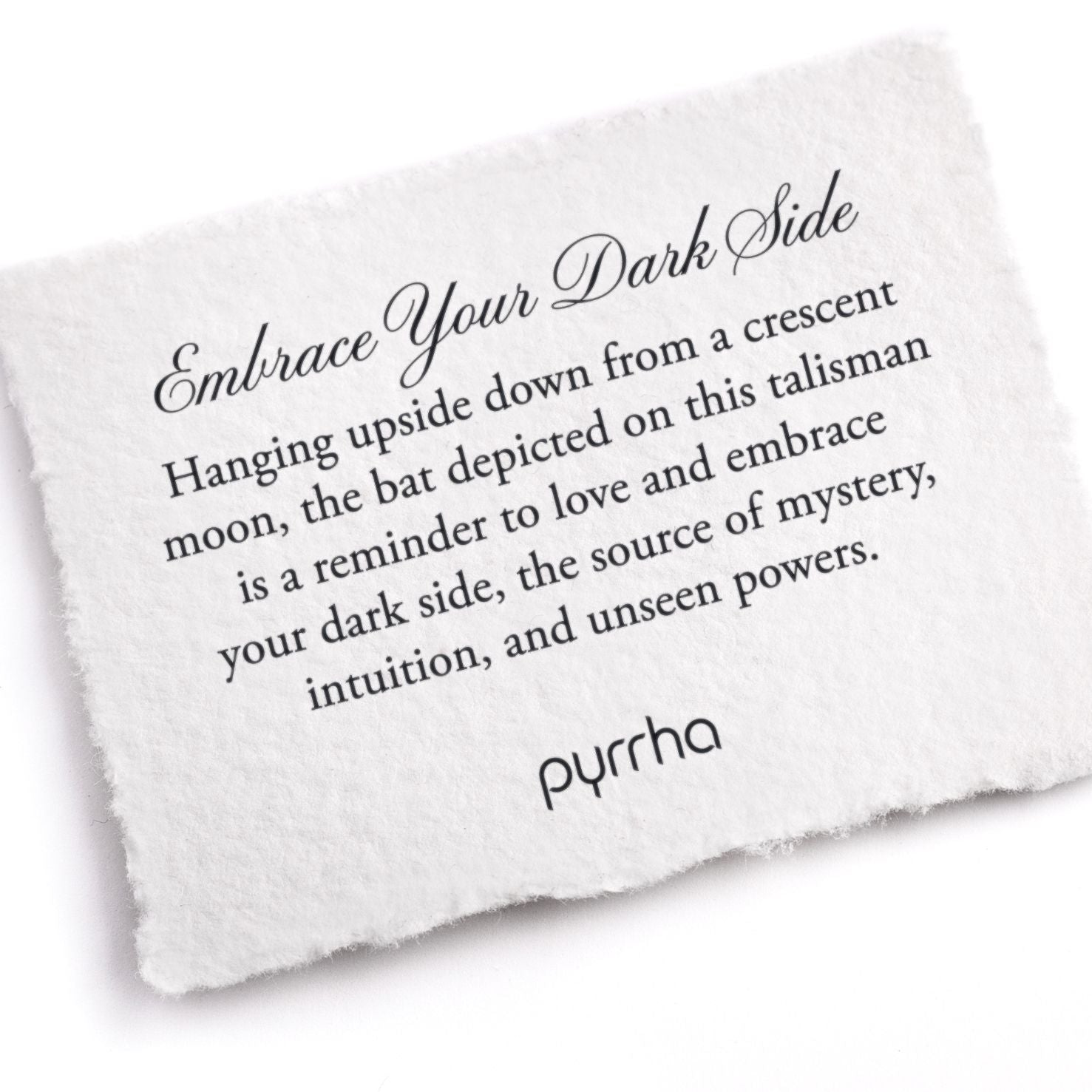 A hand-torn, letterpress printed card describing the meaning for Pyrrha's Embrace Your Dark Side Talisman
