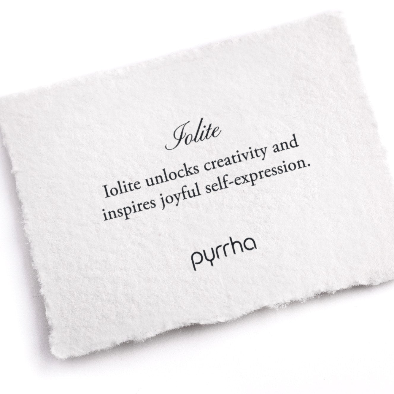 A hand-torn, letterpress printed card describing the meaning for Pyrrha's Iolite stone