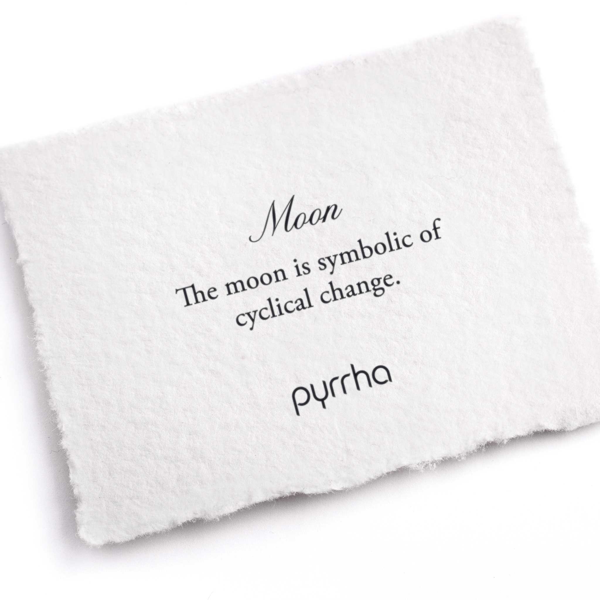 A hand-torn, letterpress printed card describing the meaning for Pyrrha's Moon Charm