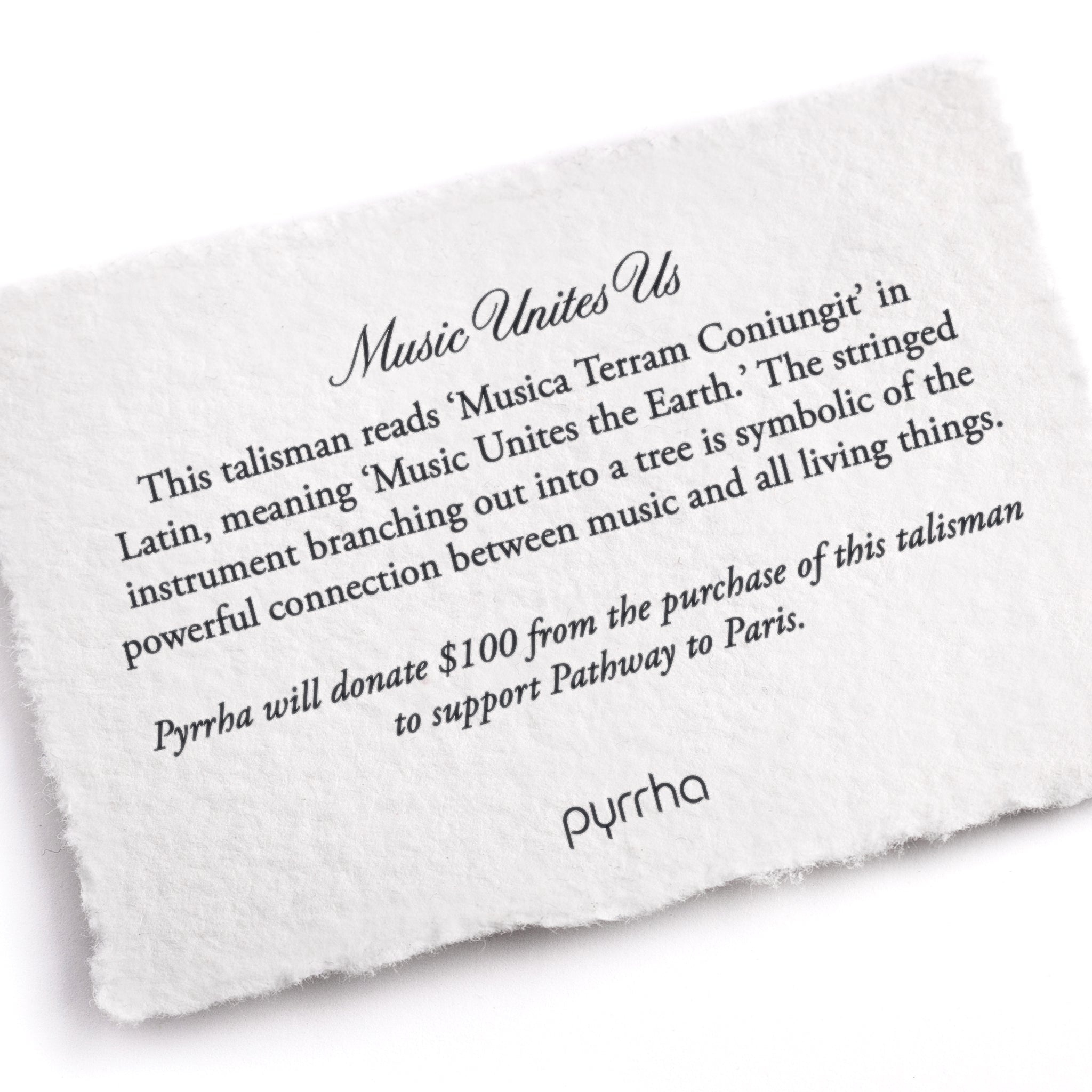 A hand-torn, letterpress printed card describing the meaning for Pyrrha's Music Unites Us Talisman