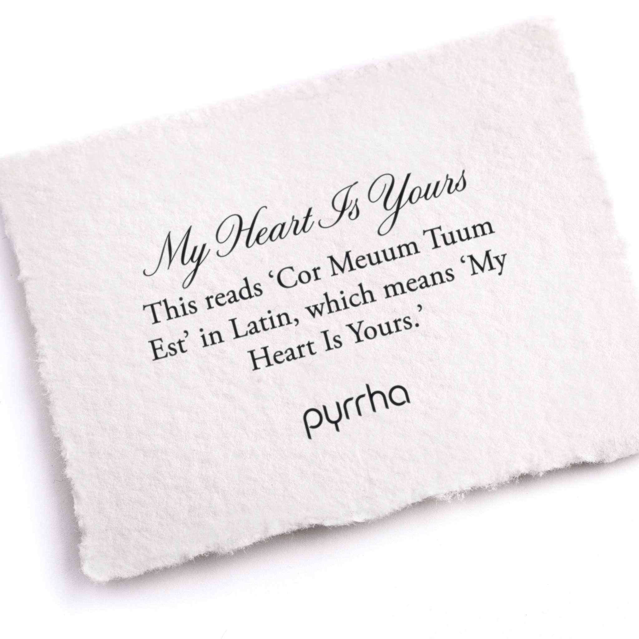 A hand-torn, letterpress printed card describing the meaning for Pyrrha's My Heart is Yours Latin Textured Band Ring
