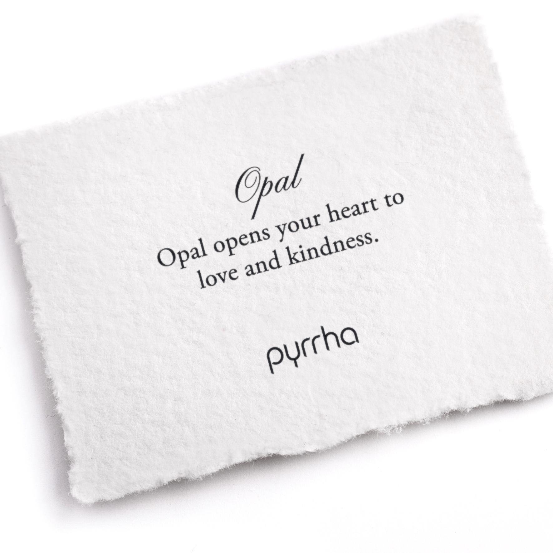 A hand-torn, letterpress printed card describing the meaning for Pyrrha's Opal stone