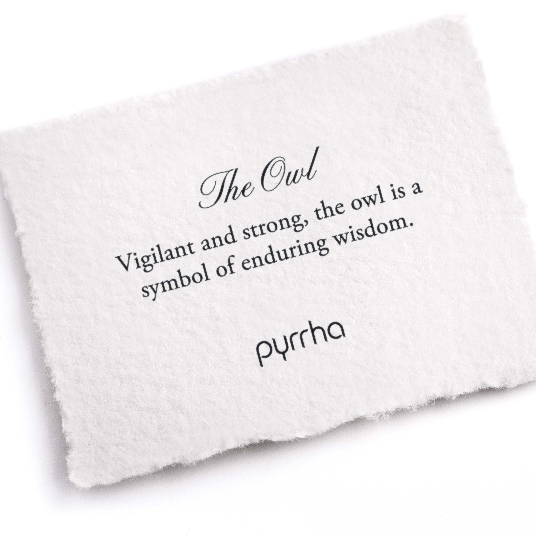 A hand-torn, letterpress printed card describing the meaning for Pyrrha's Owl Pin