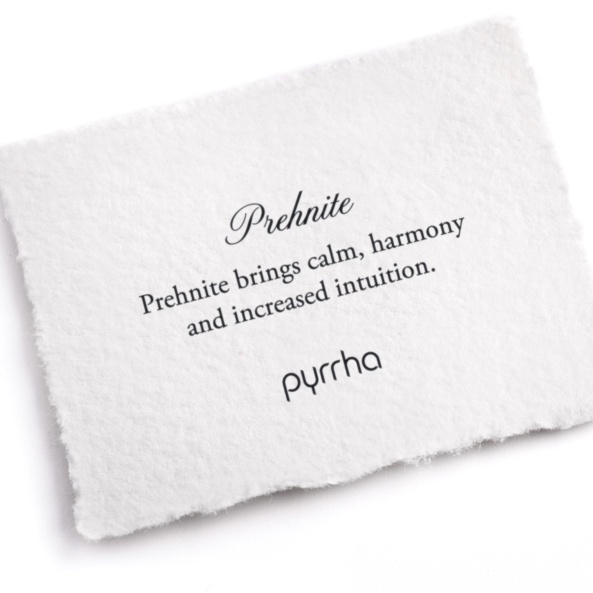 A hand-torn, letterpress printed card describing the meaning for Pyrrha's Prehnite stone