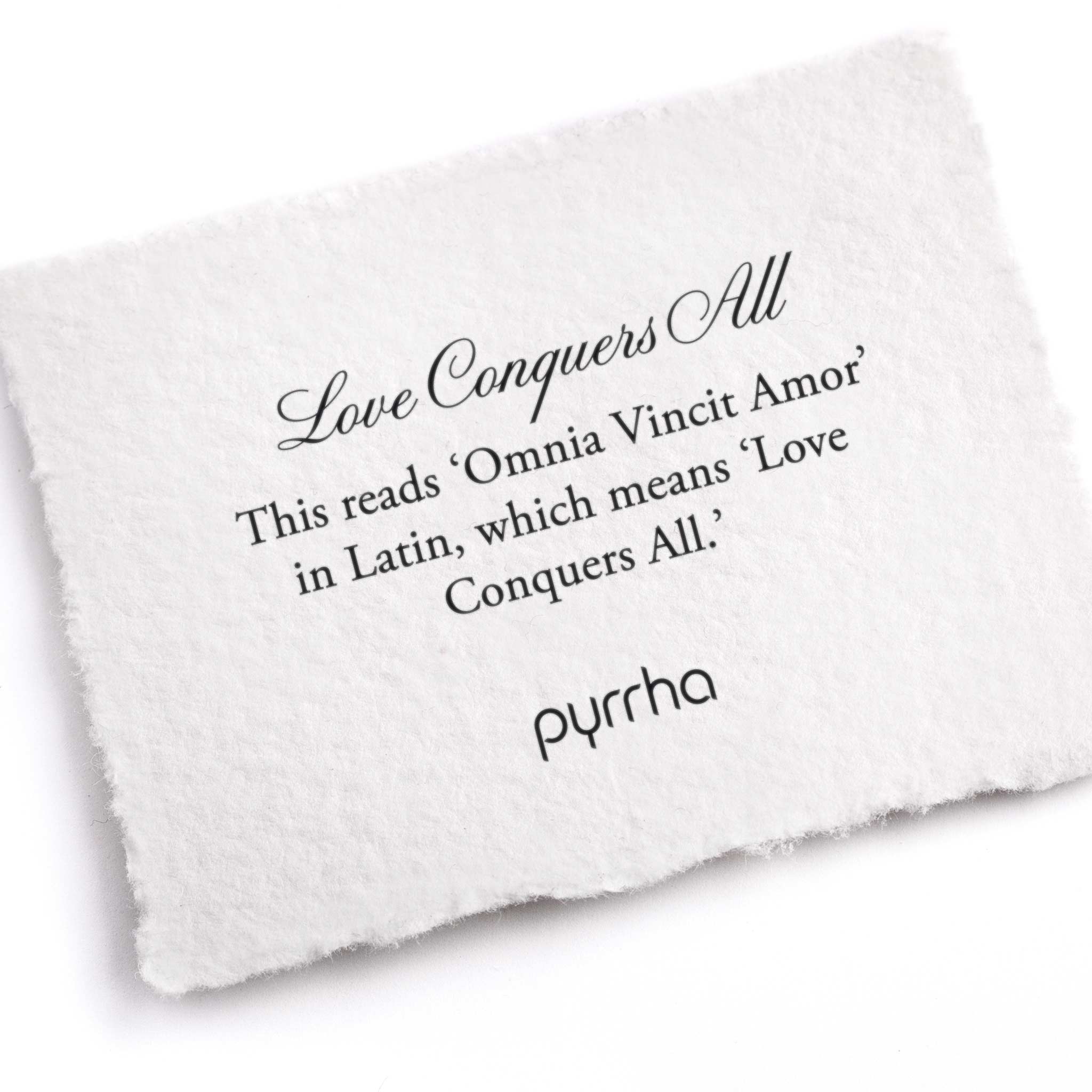 A hand-torn, letterpress printed card describing the meaning for Pyrrha's Love Conquers All Ring