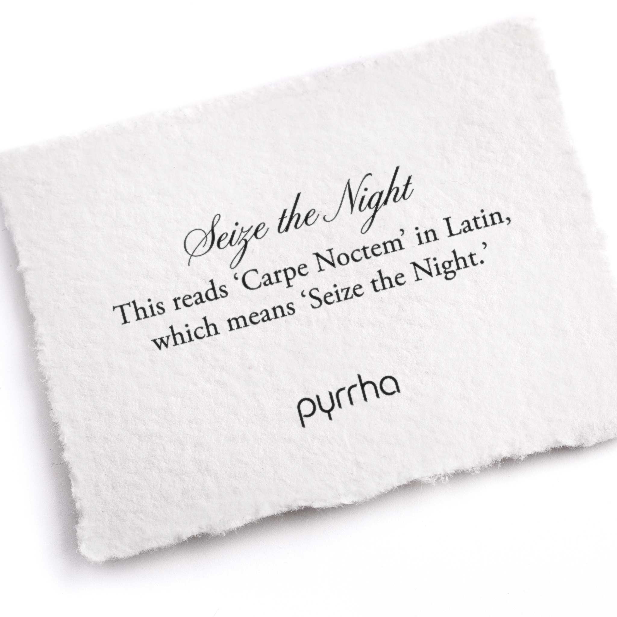 A hand-torn, letterpress printed card describing the meaning for Pyrrha's Seize the Night Latin Motto Band Ring