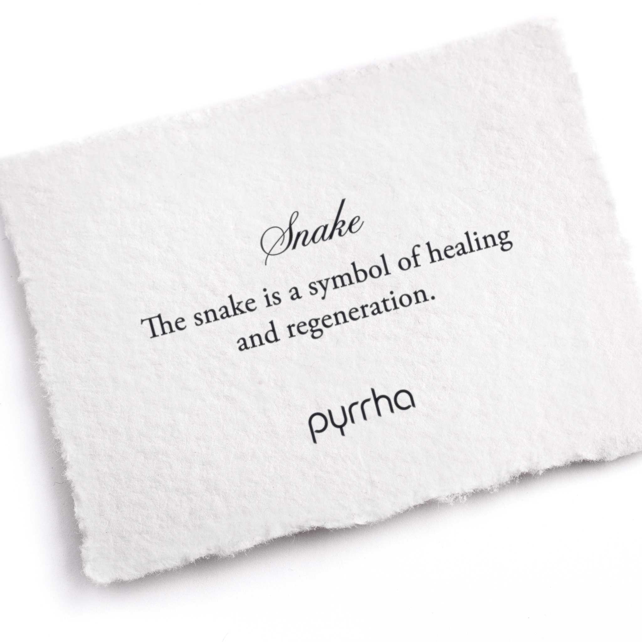 A hand-torn, letterpress printed card describing the meaning for Pyrrha's Snake Charm