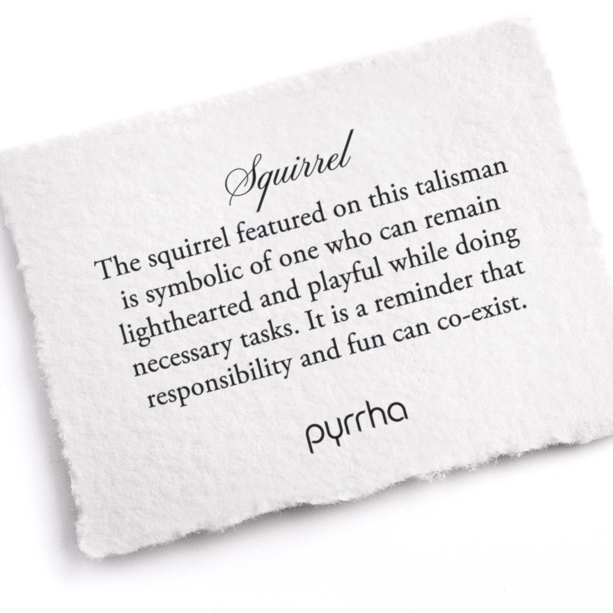 A hand-torn, letterpress printed card describing the meaning for Pyrrha's Squirrel Talisman