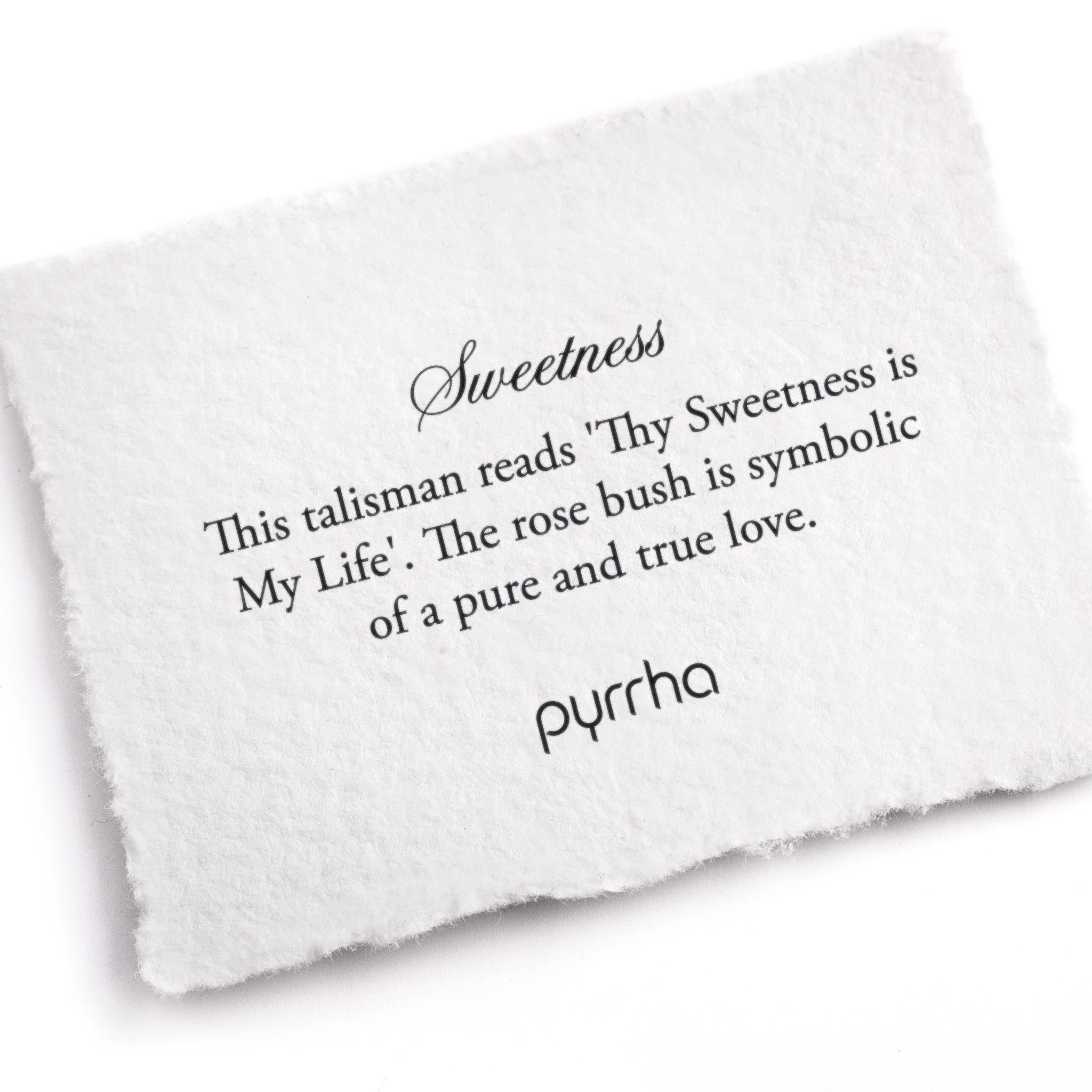A hand-torn, letterpress printed card describing the meaning for Pyrrha's Sweetness Talisman