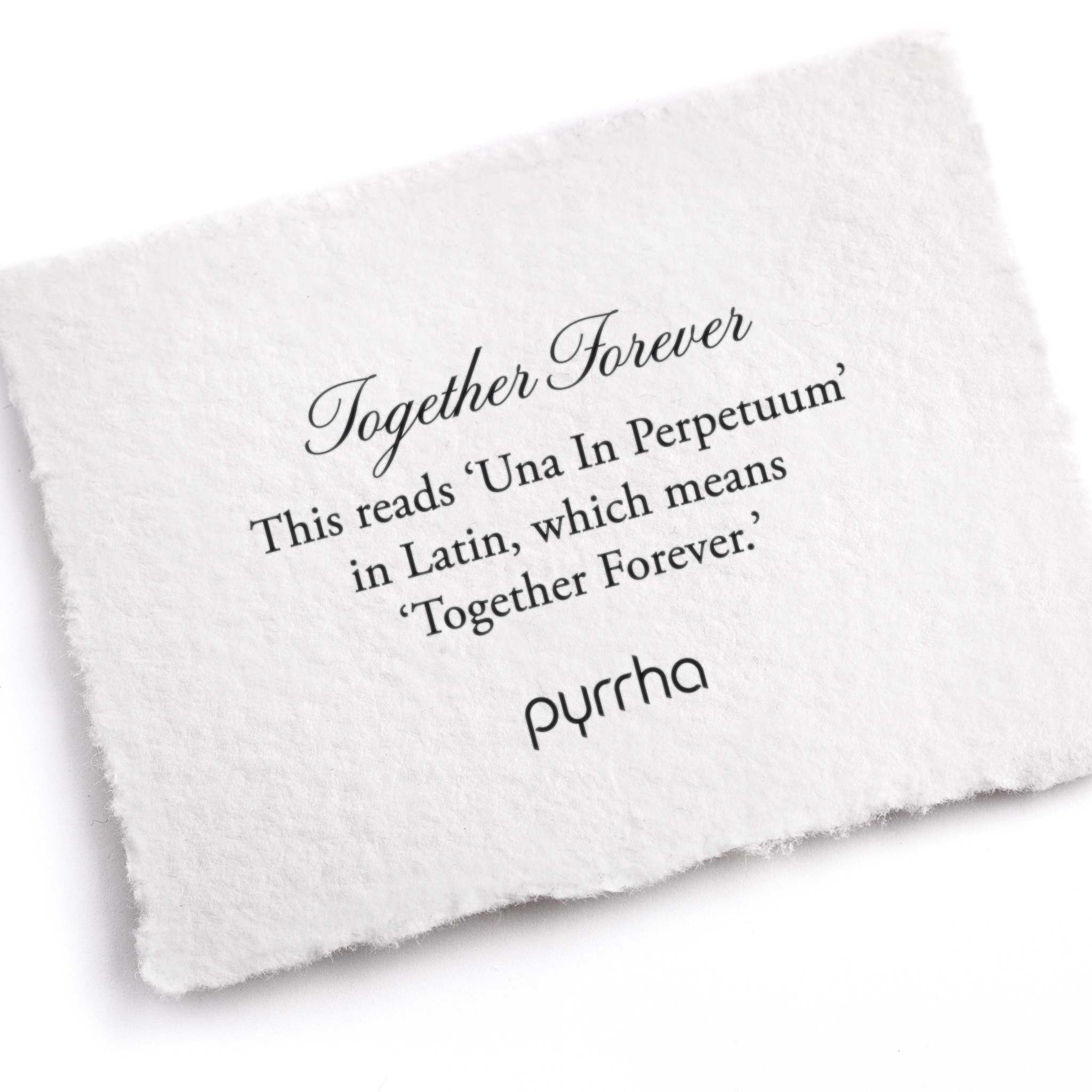A hand-torn, letterpress printed card describing the meaning for Pyrrha's Together Forever Latin Textured Band Ring