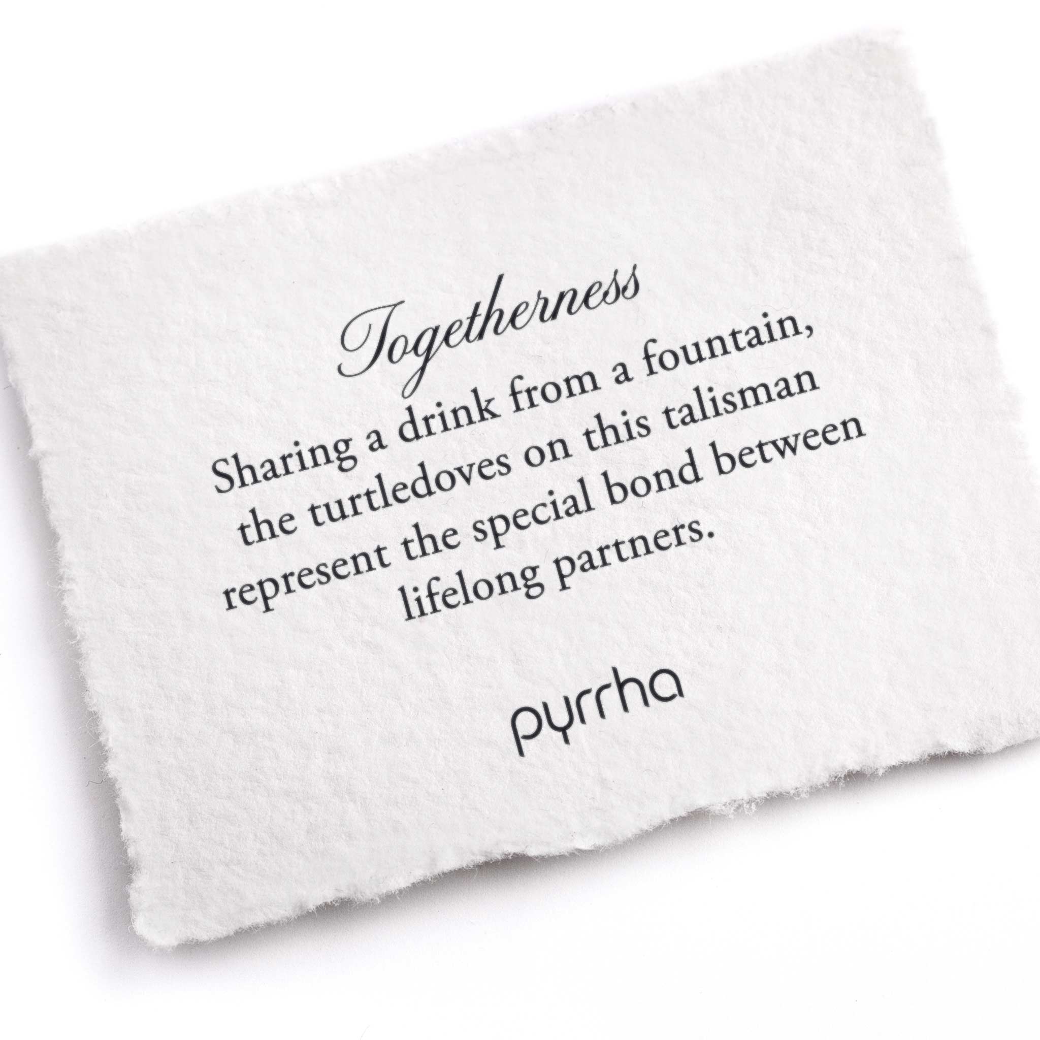 A hand-torn, letterpress printed card describing the meaning for Pyrrha's Togetherness Talisman