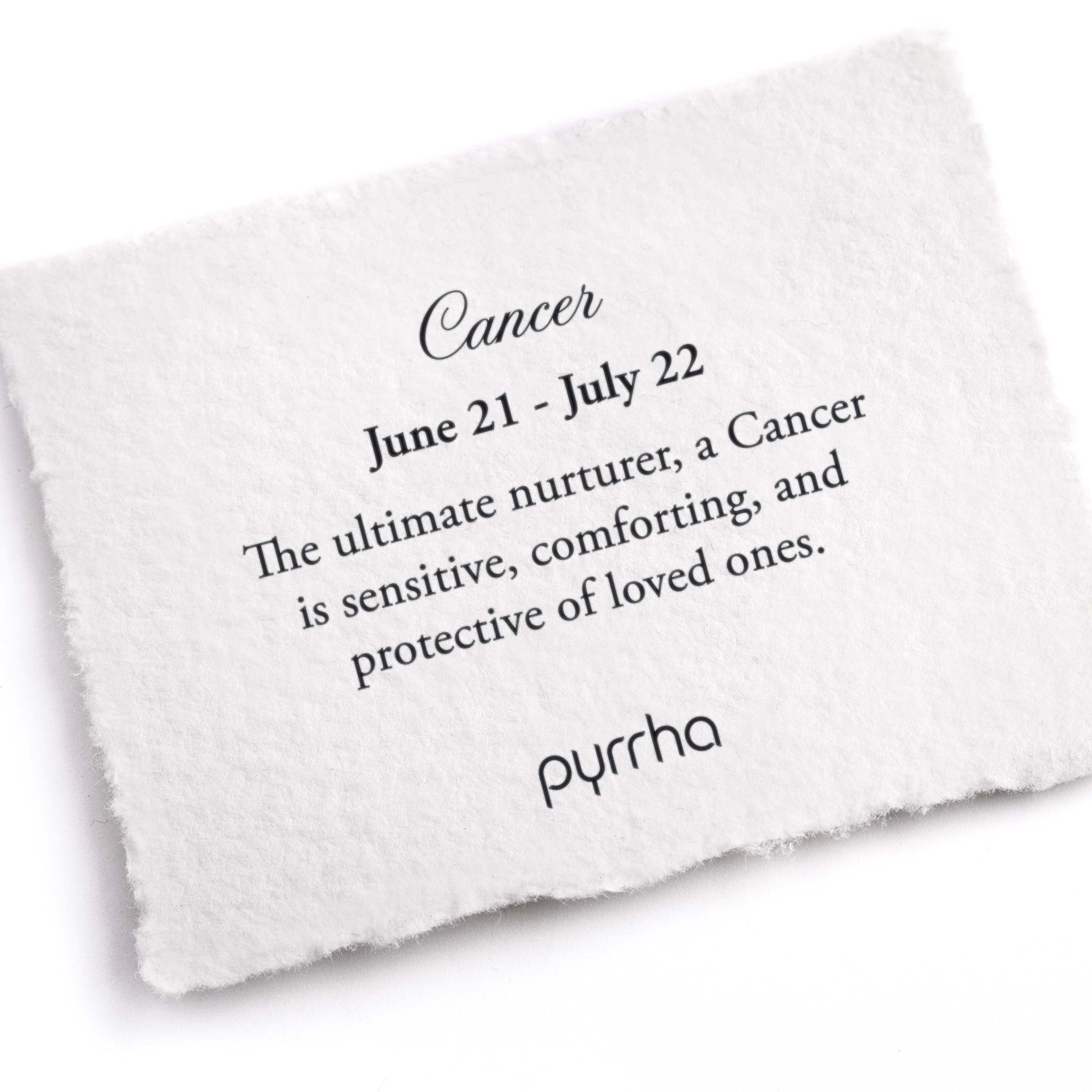 A hand-torn, letterpress printed card describing the meaning for Pyrrha's Cancer Zodiac Talisman