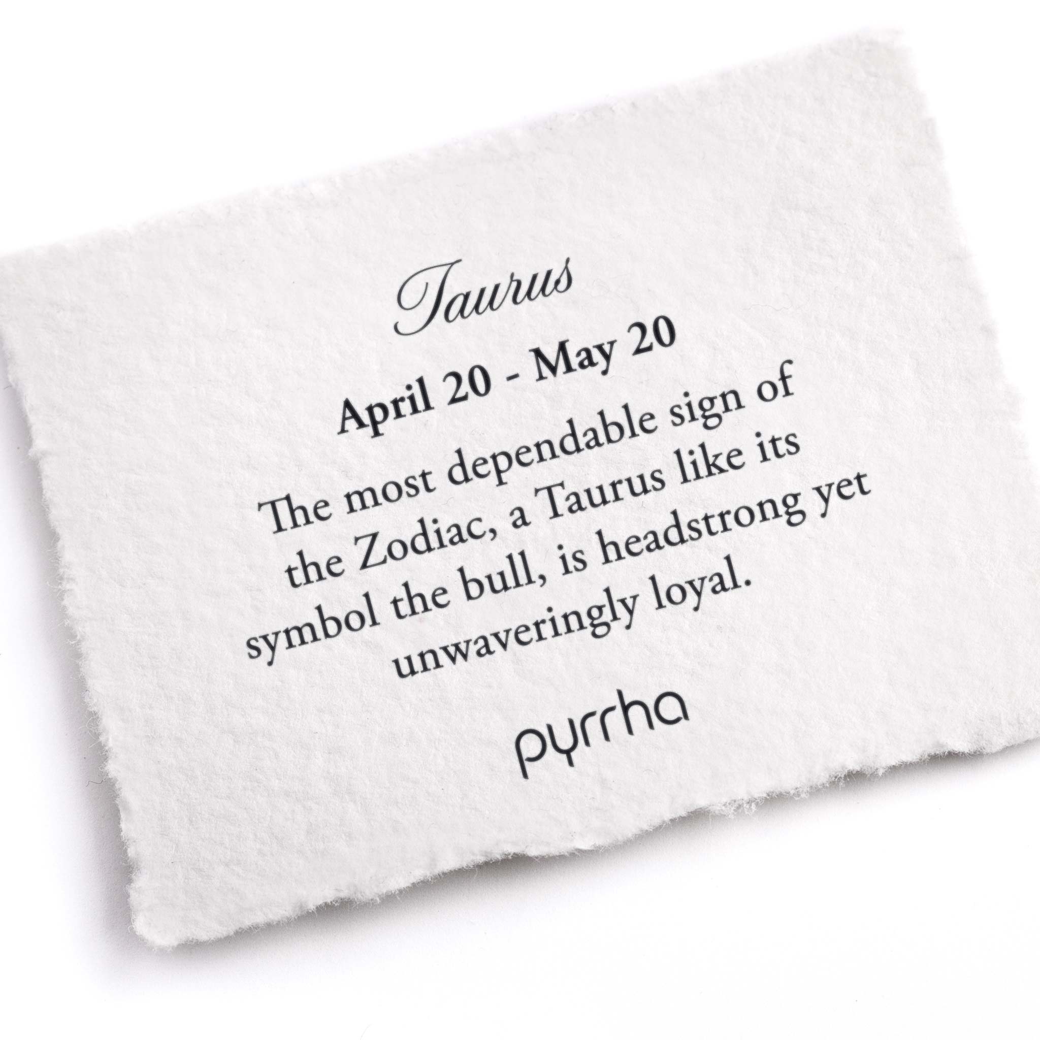A hand-torn, letterpress printed card describing the meaning for Pyrrha's Taurus Zodiac Talisman